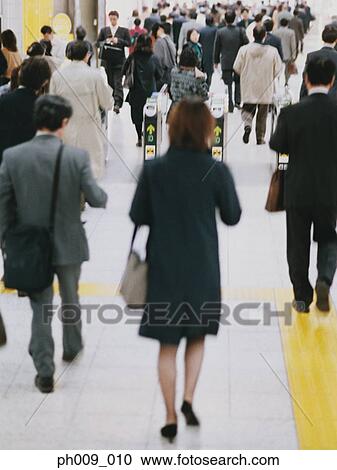Commuters going though turnstile (blurred motion) View Large Photo Image Stock Image - Commuters going though turnstile (blurred motion) . Fotosearch