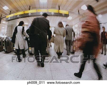 Commuters going though turnstile (blurred motion) View Large Photo Image Stock Image - Commuters going though turnstile (blurred motion) . Fotosearch