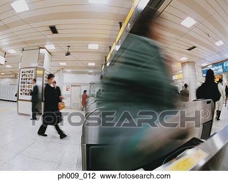 Commuters going though turnstile (blurred motion) View Large Photo Image Stock Image - Commuters going though turnstile (blurred motion) . Fotosearch