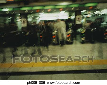 Commuters going though turnstile (blurred motion) View Large Photo Image Stock Photograph - Commuters going though turnstile (blurred motion) . Fotosearch