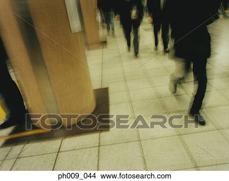 Commuters walking in subway passageway (blurred motion) View Large Photo Image Picture - Commuters walking in subway passageway (blurred motion) . Fotosearch