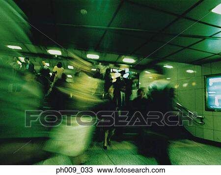Commuters walking in subway passageway (blurred motion) View Large Photo Image Stock Image - Commuters walking in subway passageway (blurred motion) . Fotosearch