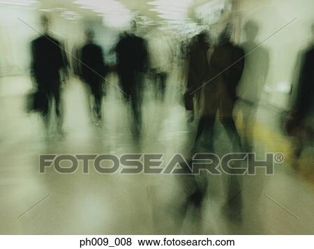 Stock Photo - Commuters walking in subway passageway (blurred motion) . Fotosearch