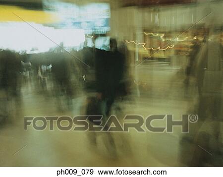 Stock Photo - Commuters walking in subway passageway (blurred motion) . Fotosearch