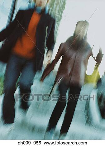 Couple descending stairs (blurred motion) View Large Photo Image Stock Photography - Couple descending stairs (blurred motion) . Fotosearch