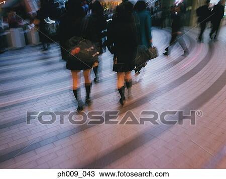 Crowd walking down shopping atrium, (blurred motion) View Large Photo Image Stock Image - Crowd walking down shopping atrium, (blurred motion). Fotosearch