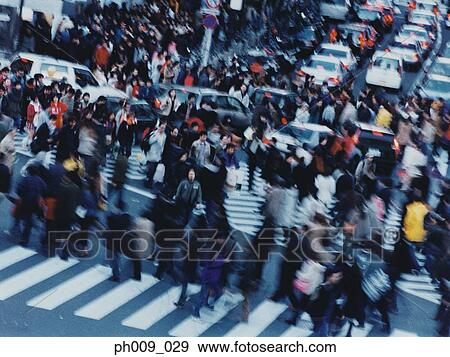 Large crowd of people crossing city street, Shibuya, Tokyo, Japan View Large Photo Image Stock Photo - Large crowd of people crossing city street, Shibuya, Tokyo, Japan . Fotosearch
