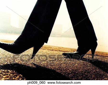Woman walking on pavement View Large Photo Image Stock Image - Woman walking on pavement. Fotosearch