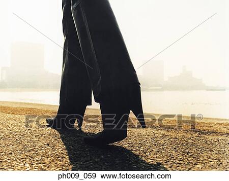 Woman walking on pavement View Large Photo Image Stock Photo - Woman walking on pavement. Fotosearch