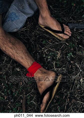 Picture - A man's legs wearing Japanese slippers. Fotosearch