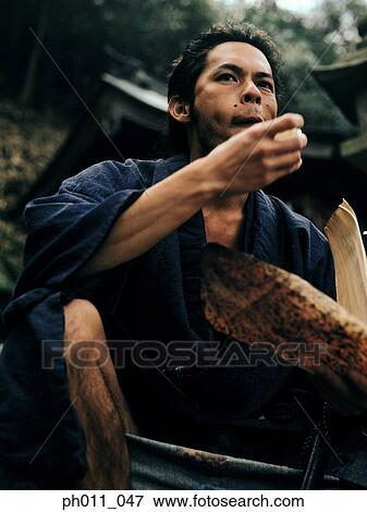 Samurai warrior eating food View Large Photo Image Stock Photo - Samurai warrior eating food. Fotosearch