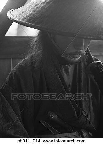 Samurai warrior in a conical hat looking down View Large Photo Image Picture - Samurai warrior in a conical hat looking down. Fotosearch