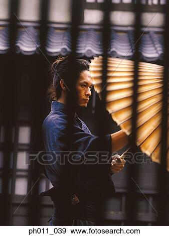 Stock Photo - Samurai warrior keeping an umbrella. Fotosearch