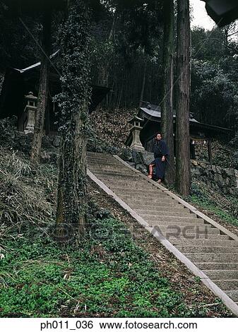 Samurai warrior leaning against a tree along a slope of steps View Large Photo Image Stock Photograph - Samurai warrior leaning against a tree along a slope of steps. Fotosearch