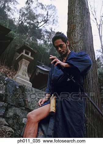 Samurai warrior leaning against a tree View Large Photo Image Stock Photography - Samurai warrior leaning against a tree. Fotosearch