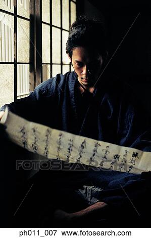 Stock Photo - Samurai warrior reading a Japanese document. Fotosearch