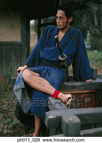 Samurai warrior sitting on a well View Large Photo Image Stock Photo - Samurai warrior sitting on a well. Fotosearch