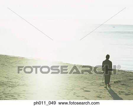 Stock Photo - Samurai warrior standing at the beach. Fotosearch