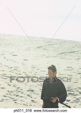 Samurai warrior standing at the seaside View Large Photo Image Stock Photo - Samurai warrior standing at the seaside. Fotosearch