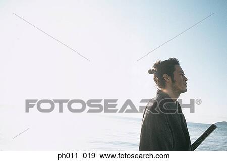 Samurai warrior standing at the seaside View Large Photo Image Stock Photo - Samurai warrior standing at the seaside. Fotosearch