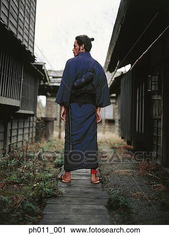 Samurai warrior standing between two rows of houses View Large Photo Image Stock Image - Samurai warrior standing between two rows of houses. Fotosearch