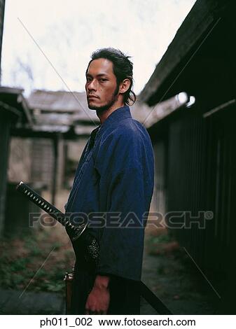 Samurai warrior standing in an alley View Large Photo Image Stock Image - Samurai warrior standing in an alley. Fotosearch