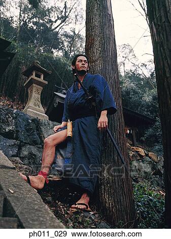 Stock Photo - Samurai warrior standing on a hill slope. Fotosearch