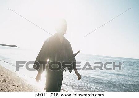 Stock Photograph - Samurai warrior walking along the seaside. Fotosearch