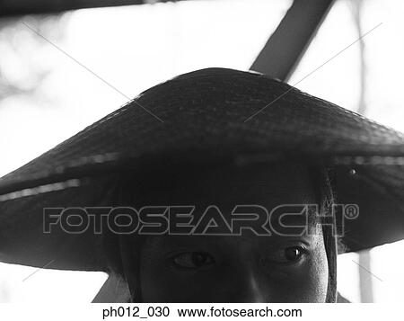 Stock Image - Portrait of a Japanese man in cone hat. Fotosearch