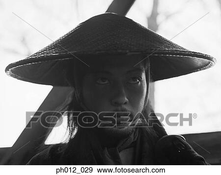 Stock Photo - Portrait of a Japanese man in cone hat. Fotosearch