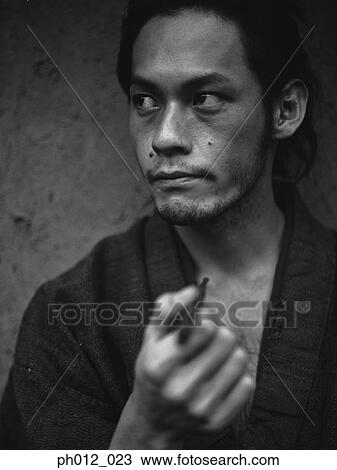 Stock Image - Portrait of a Japanese man in traditional costume. Fotosearch