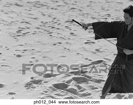 Samurai warrior holding a sword View Large Photo Image Picture - Samurai warrior holding a sword. Fotosearch