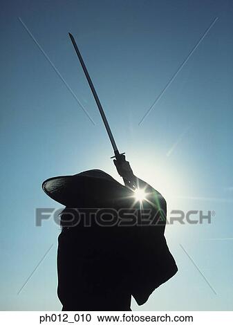 Samurai warrior holding a sword View Large Photo Image Stock Image - Samurai warrior holding a sword. Fotosearch