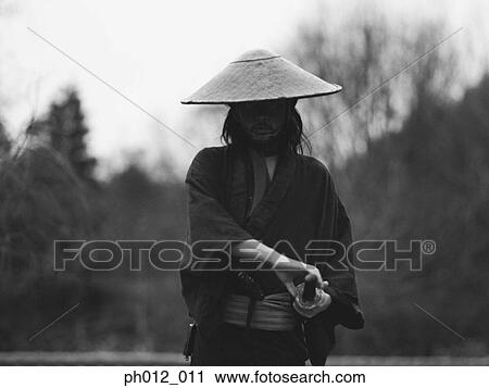 Stock Image - Samurai warrior holding a sword. Fotosearch
