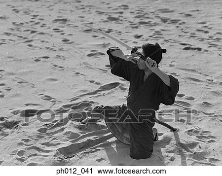 Stock Image - Samurai warrior holding a sword. Fotosearch