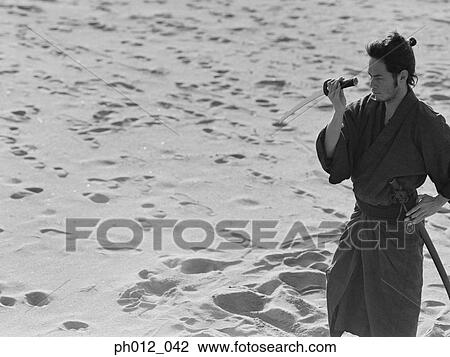 Stock Image - Samurai warrior holding a sword. Fotosearch