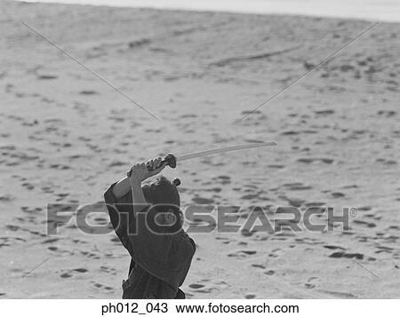 Stock Image - Samurai warrior holding a sword. Fotosearch