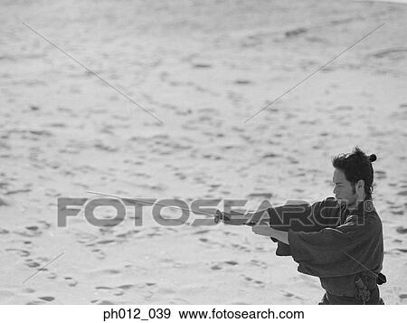 Stock Photo - Samurai warrior holding a sword. Fotosearch
