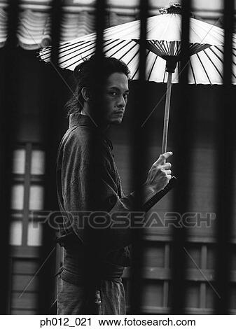 Samurai warrior holding an umbrella View Large Photo Image Stock Image - Samurai warrior holding an umbrella. Fotosearch