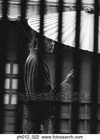 Samurai warrior holding an umbrella View Large Photo Image Stock Image - Samurai warrior holding an umbrella. Fotosearch