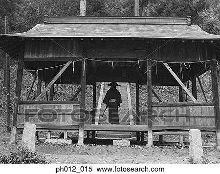Stock Photography - Samurai warrior standing in a wooden house. Fotosearch