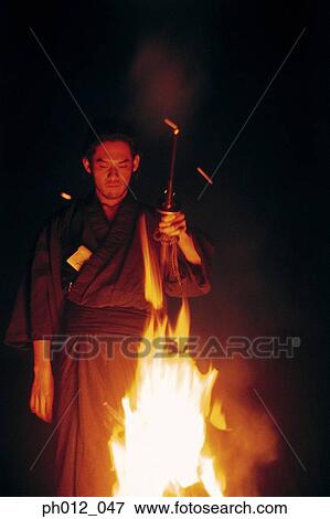 Stock Photo - Samurai warrior standing in front of burning fire. Fotosearch