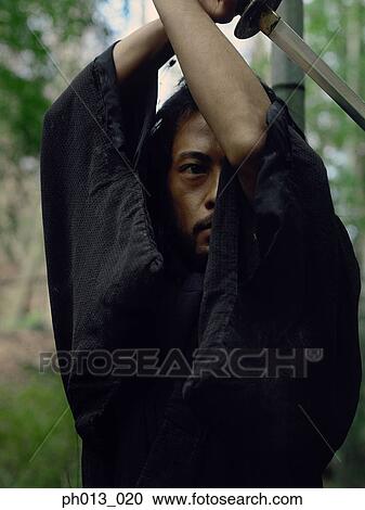 Portrait of a Samurai warrior holding a sword View Large Photo Image Stock Image - Portrait of a Samurai warrior holding a sword. Fotosearch