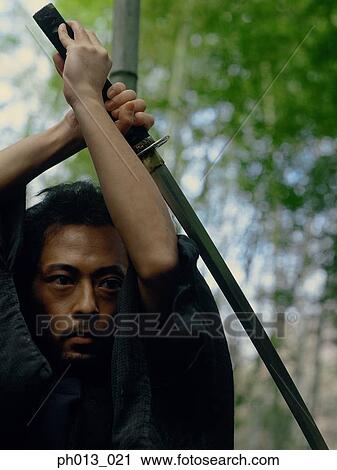 Portrait of a Samurai warrior holding a sword View Large Photo Image Stock Image - Portrait of a Samurai warrior holding a sword. Fotosearch