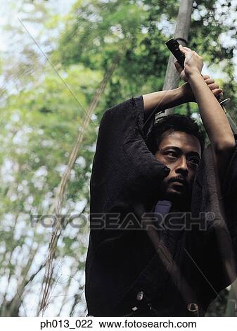 Stock Image - Portrait of a Samurai warrior holding a sword. Fotosearch