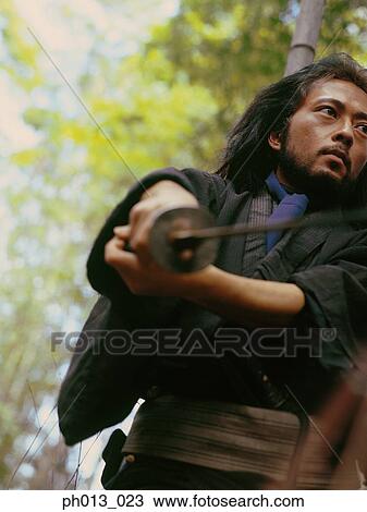Stock Image - Samurai warrior holding a sword. Fotosearch