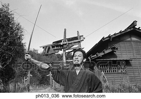 Samurai warrior holding a sword View Large Photo Image Stock Photograph - Samurai warrior holding a sword. Fotosearch