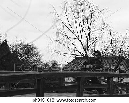 Stock Photo - Samurai warrior practicing sword play. Fotosearch