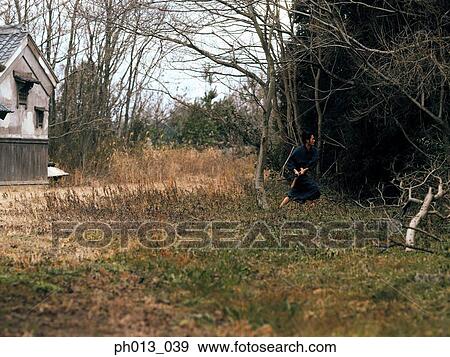 Stock Photo - Samurai warrior practicing sword play. Fotosearch