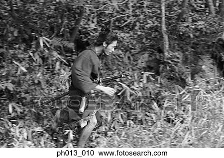 Stock Image - Samurai warrior running in an isolated land. Fotosearch